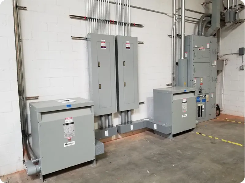 Electrical room with panels, transformers and conduit runs