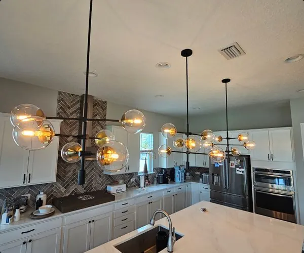 Open kitchen with globe pendants over the island