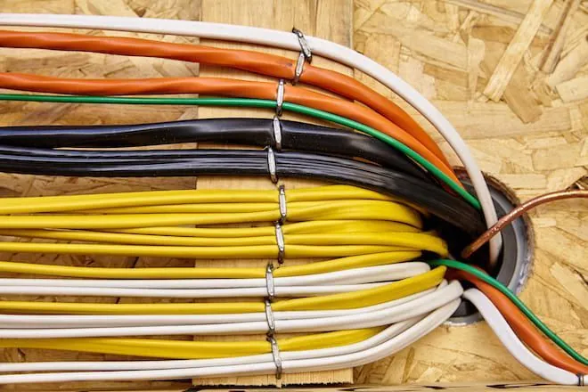 Bundle of colour-coded wires on plywood